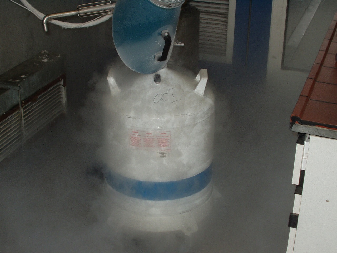 nitrogen being poured into a container causing white smoke to fall out